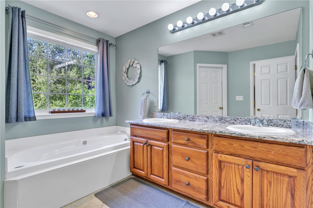 154 Hammond School Road Anderson, SC 29621 - Photo 14 of 33 This serene bathroom offers a spacious soaking tub and a functional double vanity.