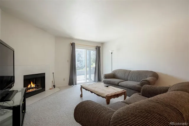 a living room with furniture large window and a flat screen tv