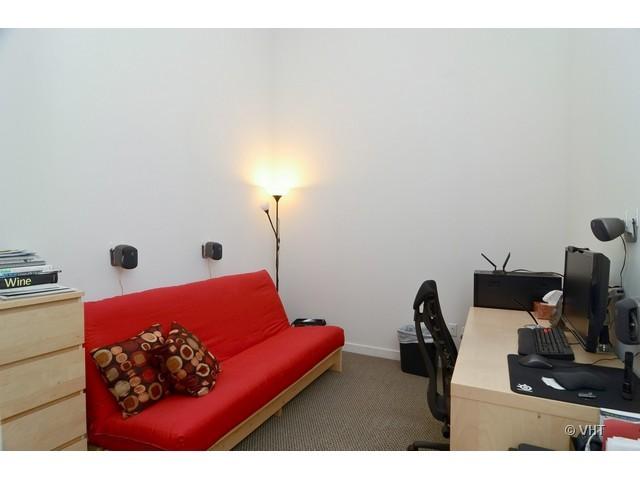 1224 West Van Buren Street, Unit 802 Chicago, IL 60607 - Photo 6 of 10 a bedroom with a bed and a flat screen tv