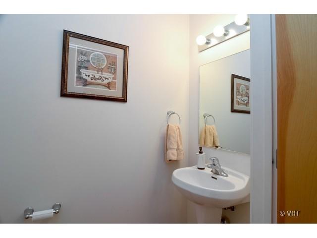 1224 West Van Buren Street, Unit 802 Chicago, IL 60607 - Photo 9 of 10 a bathroom with a sink and a mirror