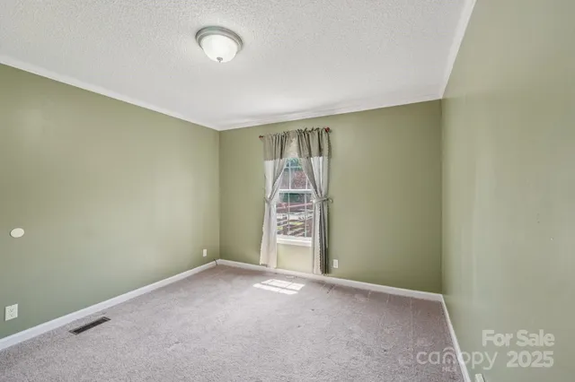 an empty room with a empty space and windows