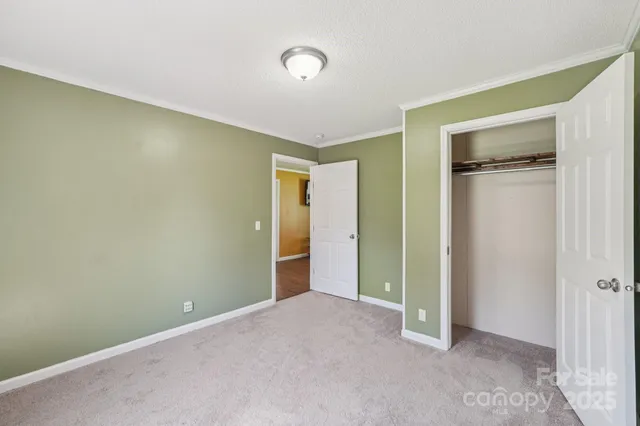 an empty room with closet and a bathroom