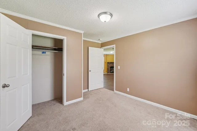 a view of an empty room and closet area