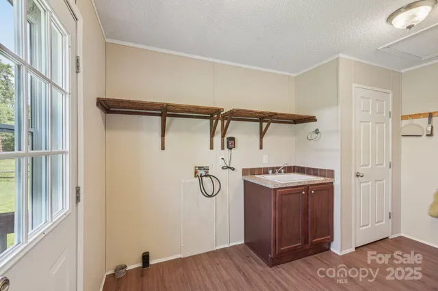 a bathroom with a granite countertop sink and a white cabinet