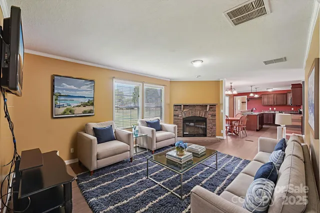 a living room with furniture fireplace and a large window