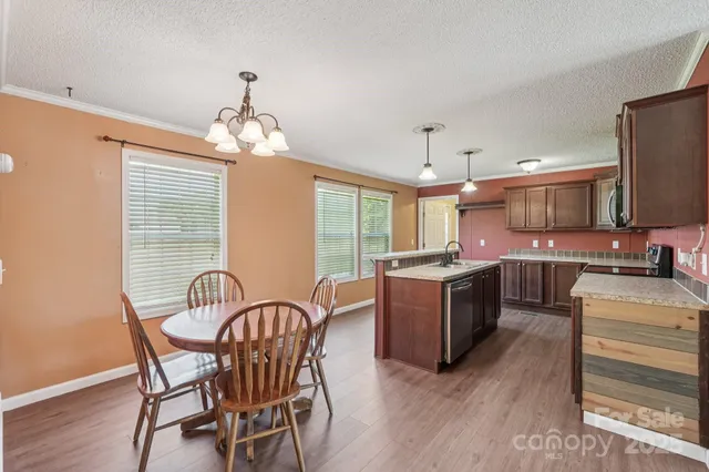 a kitchen with sink cabinets and wooden floor