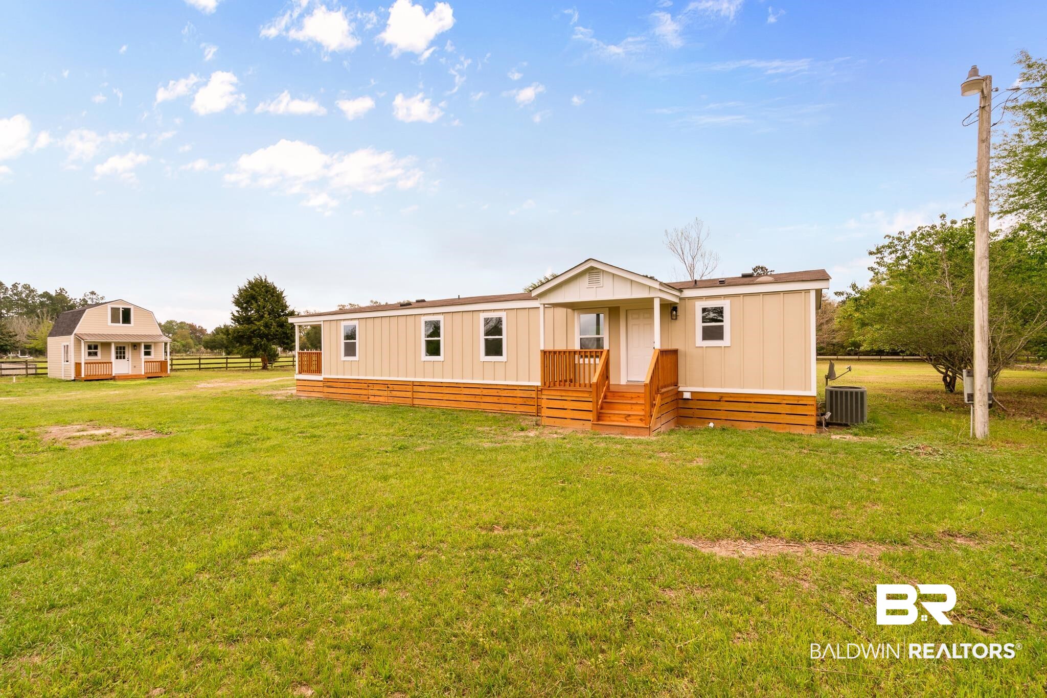 12645 Breman Road Elberta, AL 36530 - Photo 35 of 44 Rear view of house with cooling unit, a yard, and fence
