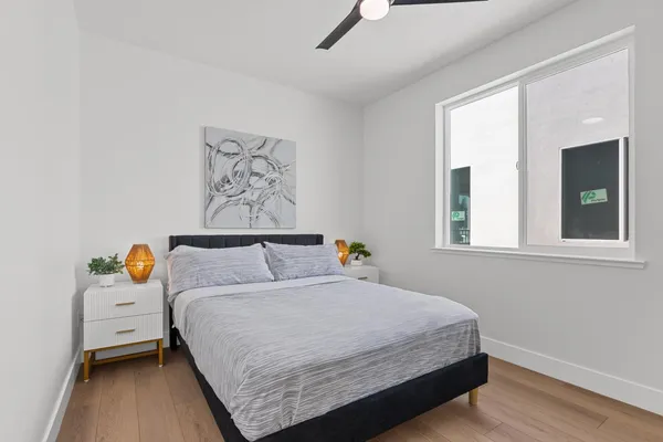 a bedroom with a bed and a window