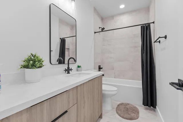 a bathroom with a sink a toilet and a bathtub