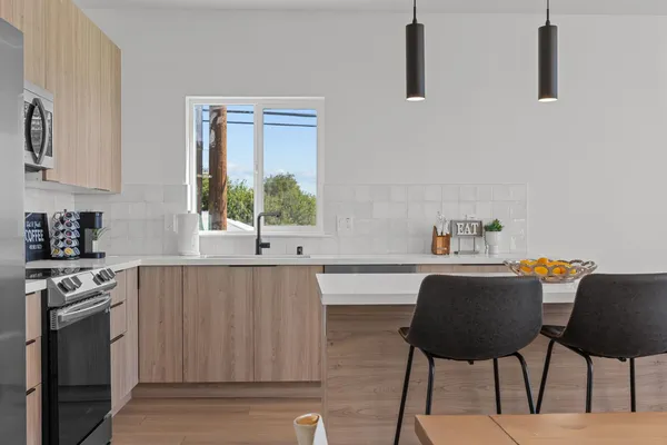 a kitchen with a stove cabinets and a table