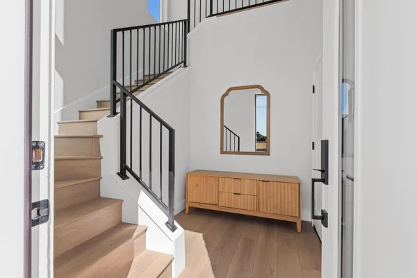 a view of entryway and hall with wooden floor