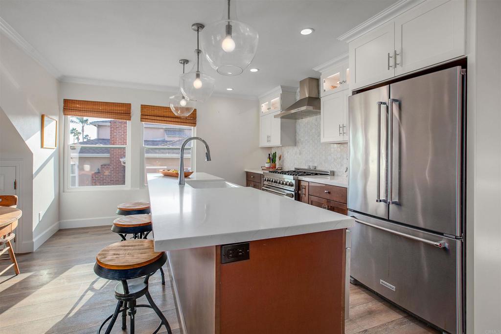 906 Leonard Avenue Oceanside, CA 92054 - Photo 11 of 53 a kitchen with stainless steel appliances granite countertop a sink refrigerator and a stove with wooden floor