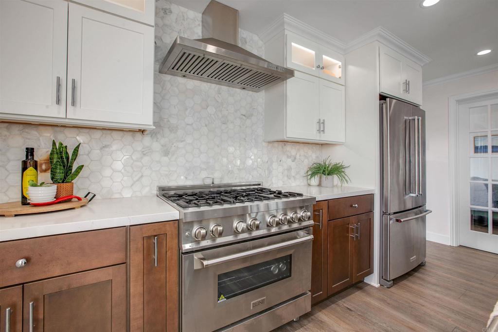906 Leonard Avenue Oceanside, CA 92054 - Photo 13 of 53 a kitchen with stainless steel appliances granite countertop a stove a refrigerator and a white cabinets