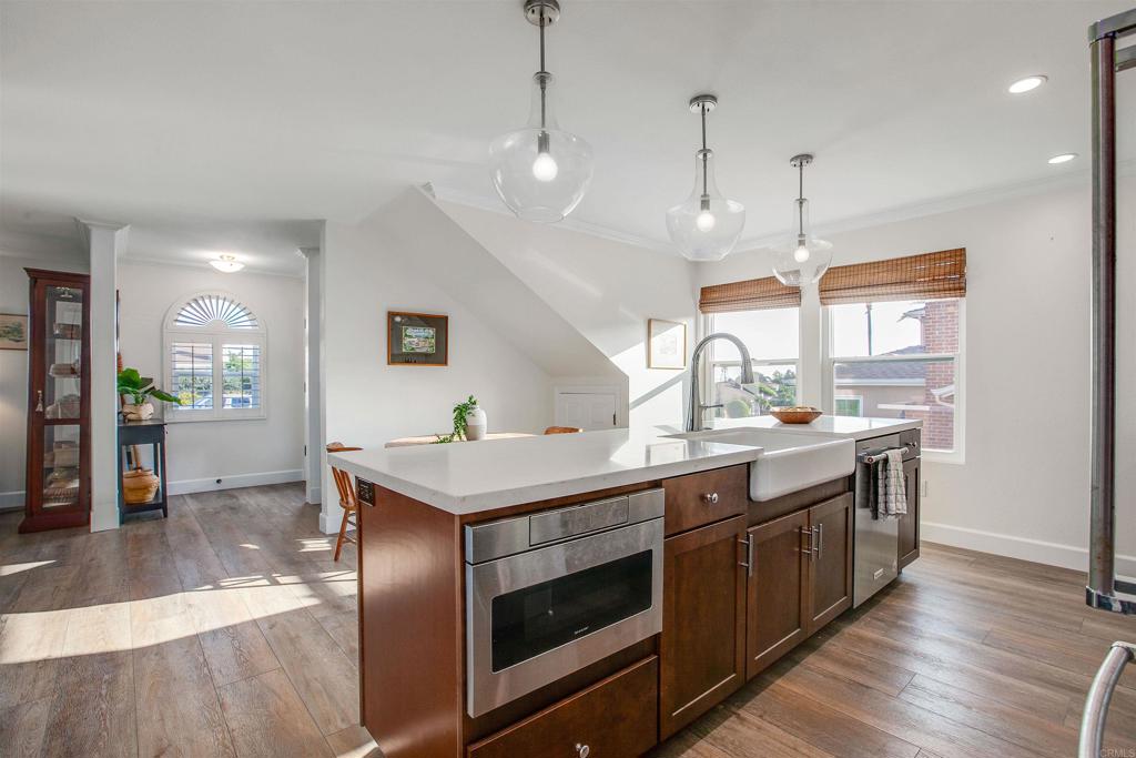 906 Leonard Avenue Oceanside, CA 92054 - Photo 14 of 53 a kitchen with stainless steel appliances granite countertop a sink a stove and a wooden floors