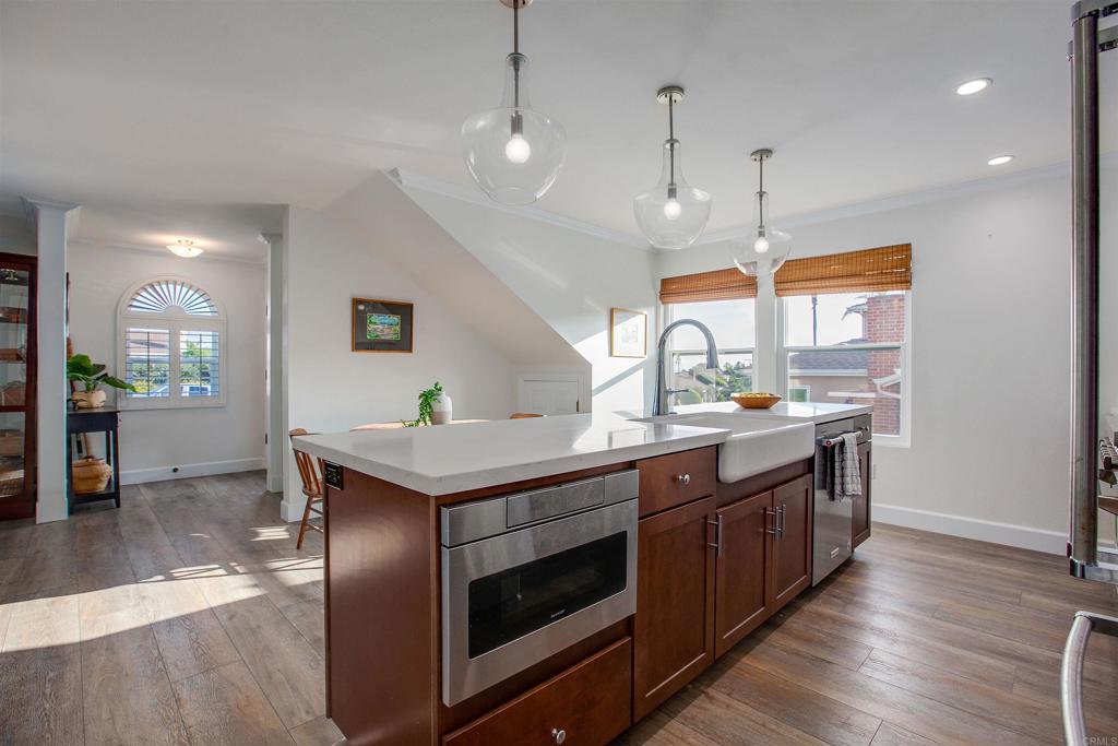 906 Leonard Avenue Oceanside, CA 92054 - Photo 16 of 53 a kitchen with stainless steel appliances granite countertop a stove and a wooden floors