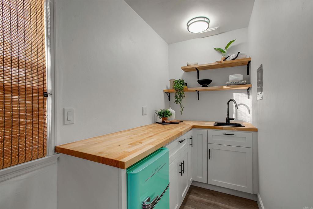 906 Leonard Avenue Oceanside, CA 92054 - Photo 39 of 53 a utility room with cabinets and wooden floor