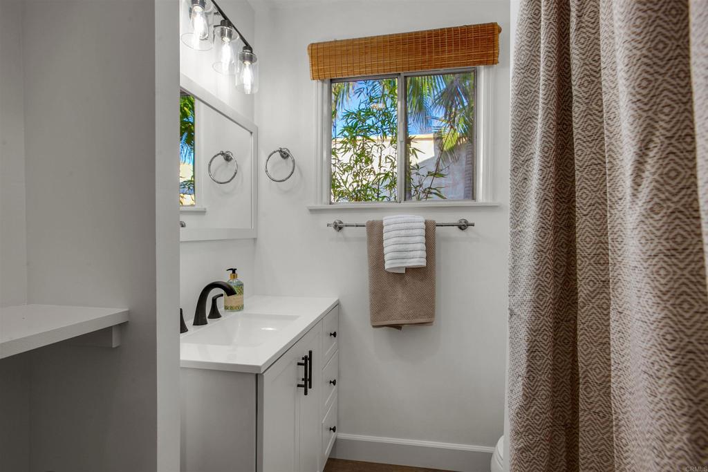 906 Leonard Avenue Oceanside, CA 92054 - Photo 40 of 53 a bathroom with a sink a mirror and window