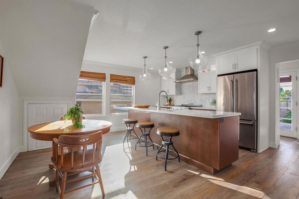 906 Leonard Avenue Oceanside, CA 92054 - Photo 10 of 53 a kitchen with kitchen island a dining table and chairs