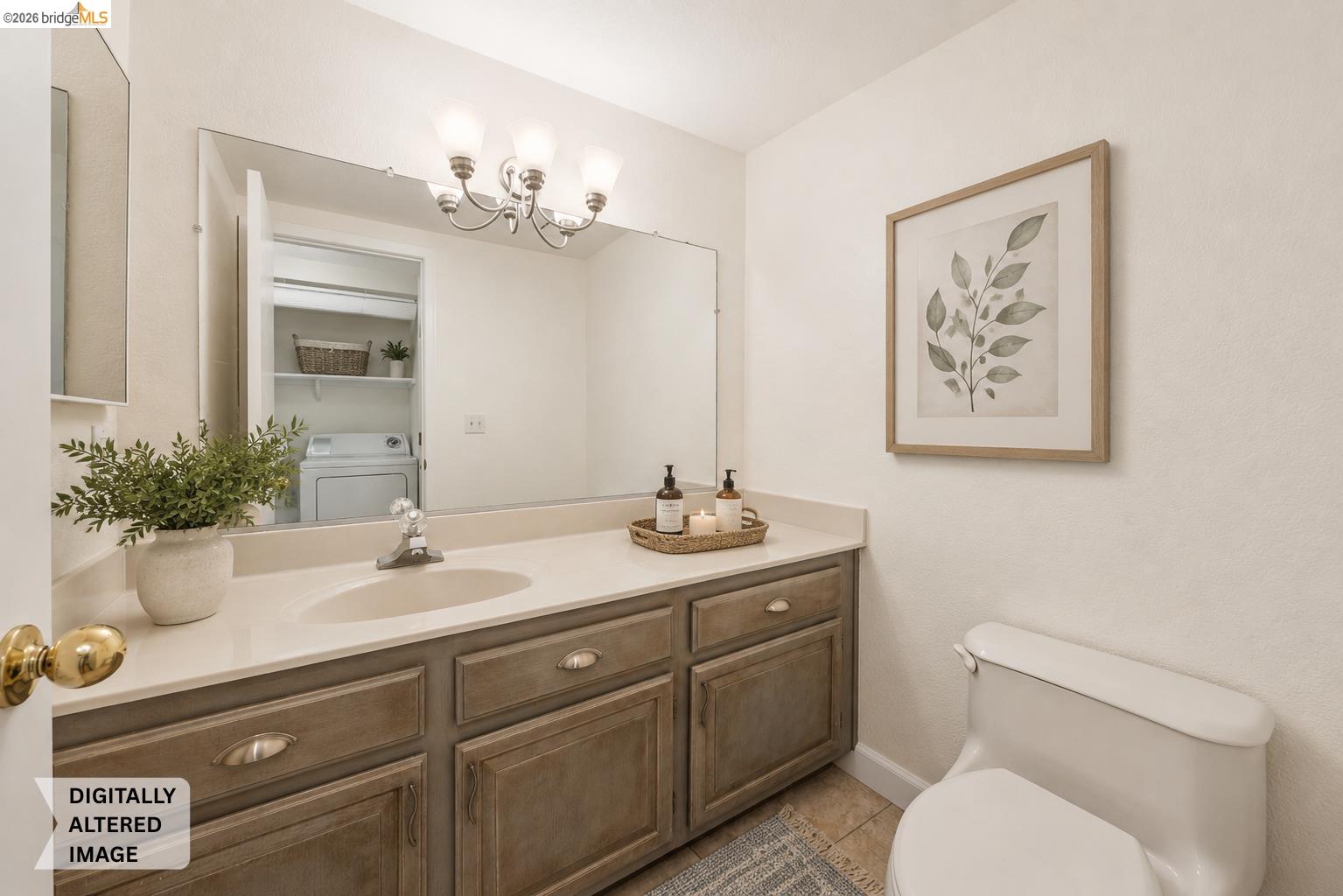 261 Redhawk Road Novato, CA 94949 - Photo 26 of 47 Bathroom vanity featuring a single basin sink, light-toned countertop, and wood-finish cabinetry with brass hardware