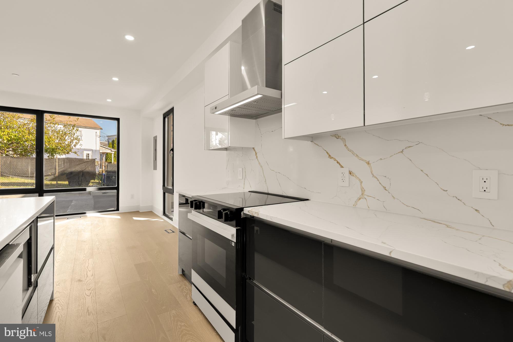 1810 Central Place Northeast, Unit 1 Washington, DC 20002 - Photo 12 of 33 a kitchen with granite countertop a sink a stove top oven a counter space and cabinets