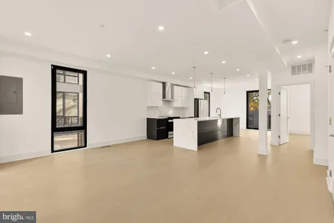 a view of kitchen with refrigerator and window