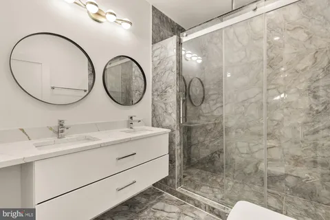 a bathroom with a toilet a sink and a mirror