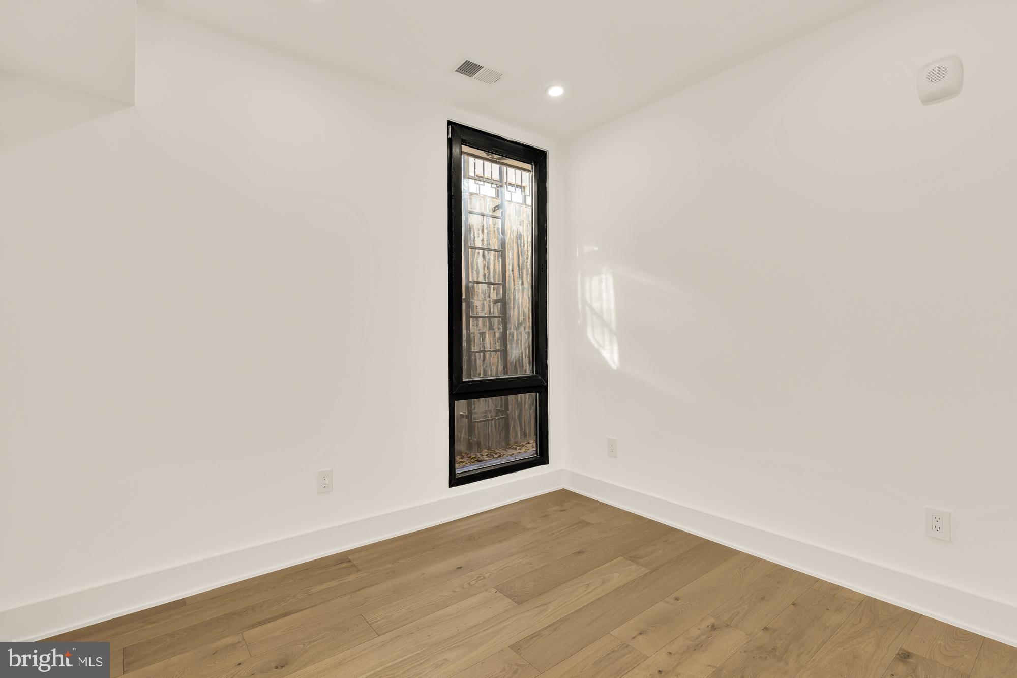 1810 Central Place Northeast, Unit 1 Washington, DC 20002 - Photo 24 of 33 an empty room with wooden floor and window