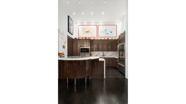 a kitchen with a sink and breakfast area