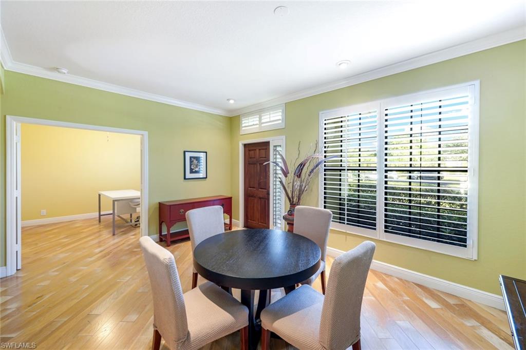 302 Sawgrass Court Naples, FL 34110 - Photo 14 of 40 a view of a dining room with furniture and wooden floor