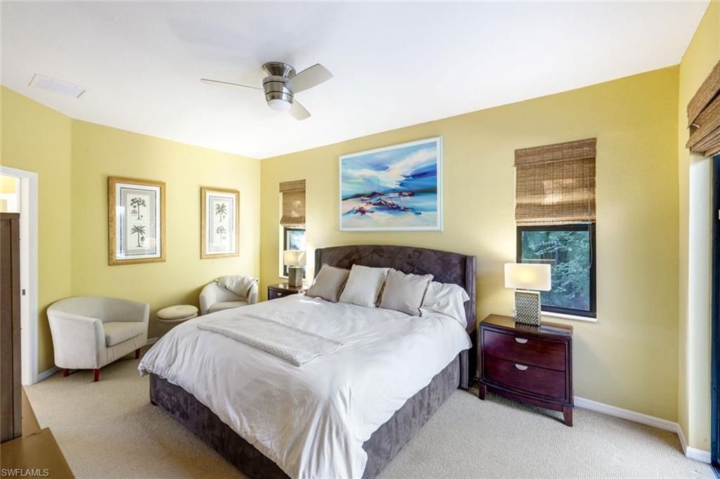302 Sawgrass Court Naples, FL 34110 - Photo 17 of 40 a bedroom with a bed and a painting on the wall