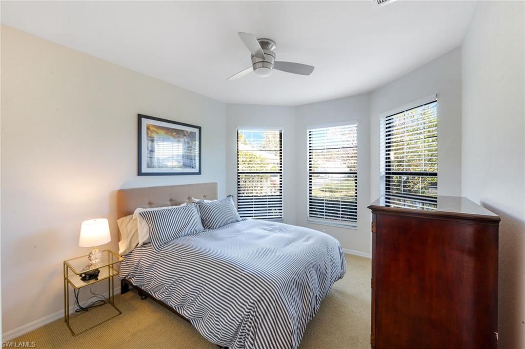 302 Sawgrass Court Naples, FL 34110 - Photo 20 of 40 a bedroom with a bed and a window