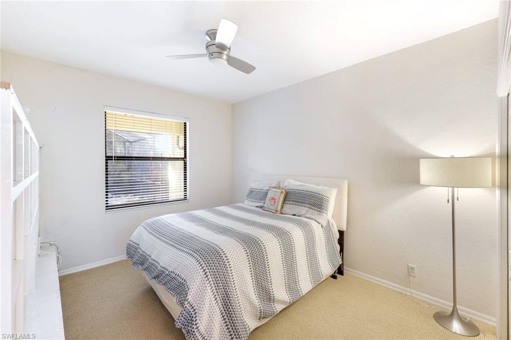 302 Sawgrass Court Naples, FL 34110 - Photo 22 of 40 a bedroom with a bed and a window