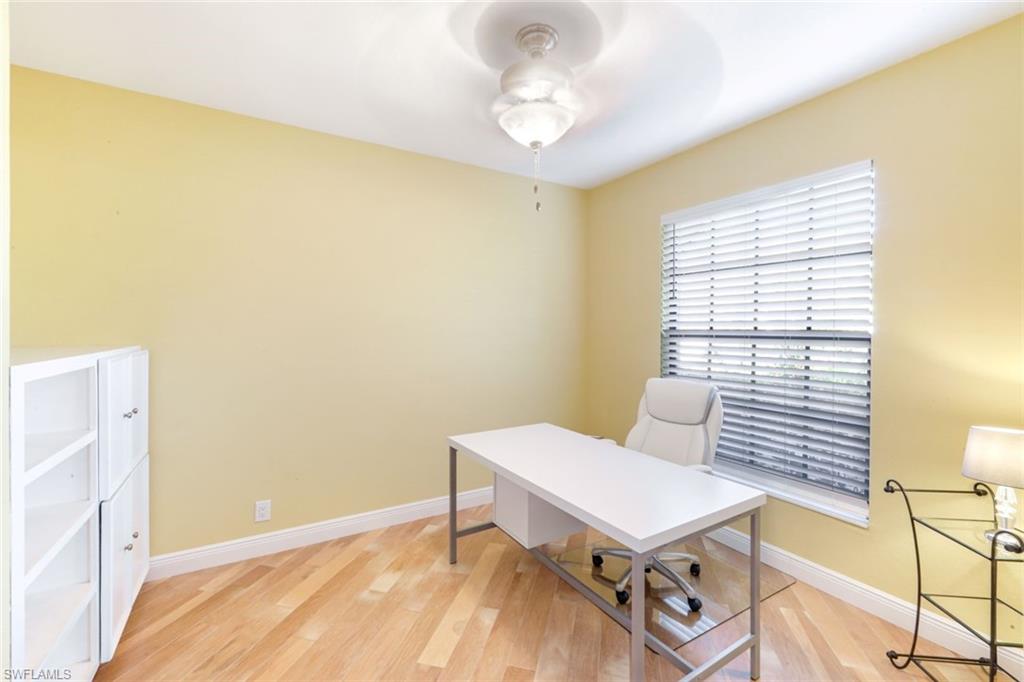 302 Sawgrass Court Naples, FL 34110 - Photo 23 of 40 a view of a bedroom with furniture and a window