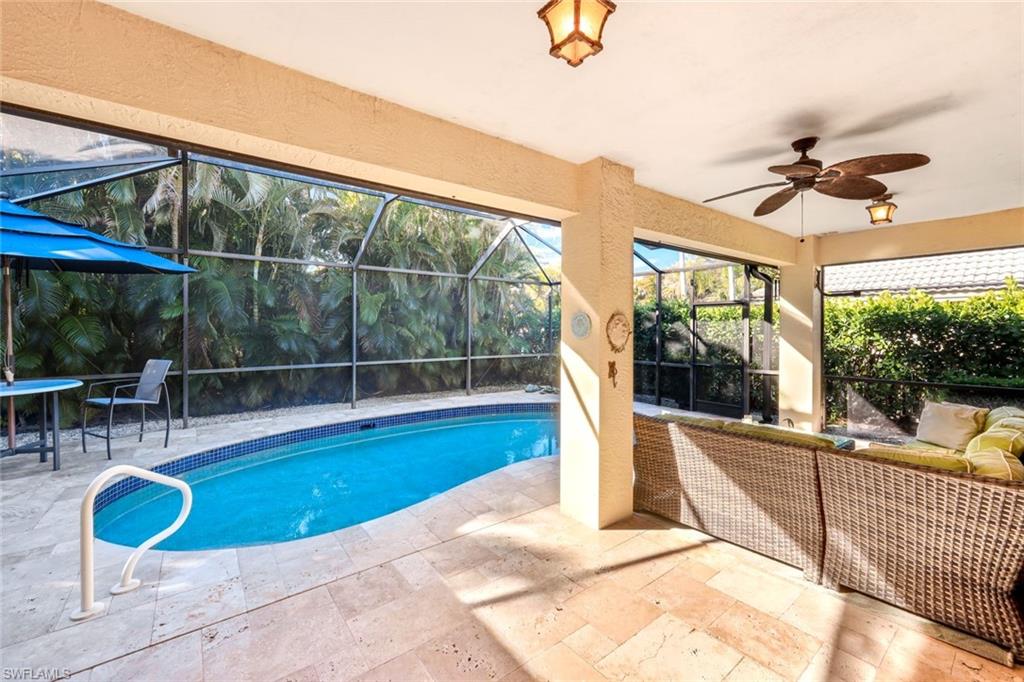 302 Sawgrass Court Naples, FL 34110 - Photo 26 of 40 a view of a swimming pool with a patio and a tub