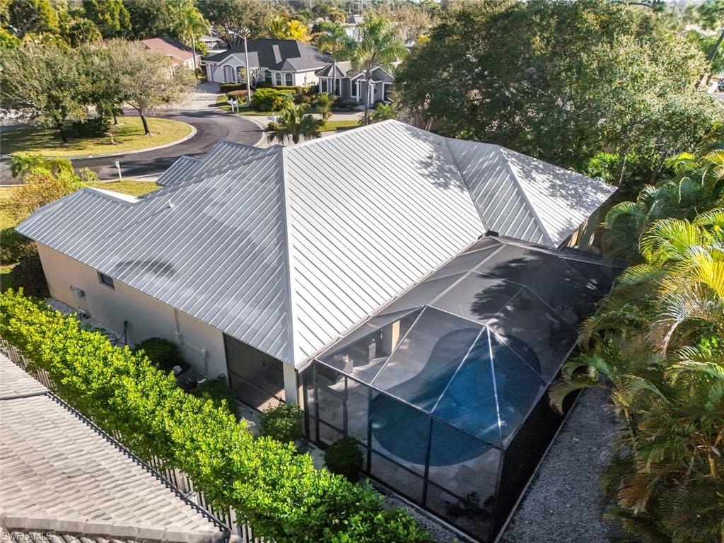 302 Sawgrass Court Naples, FL 34110 - Photo 30 of 40 a view of a house with pool and chairs