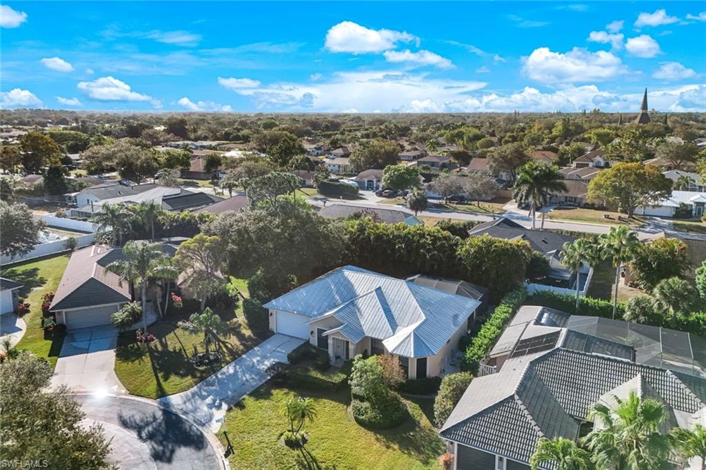 302 Sawgrass Court Naples, FL 34110 - Photo 3 of 40 an aerial view of a house with a yard
