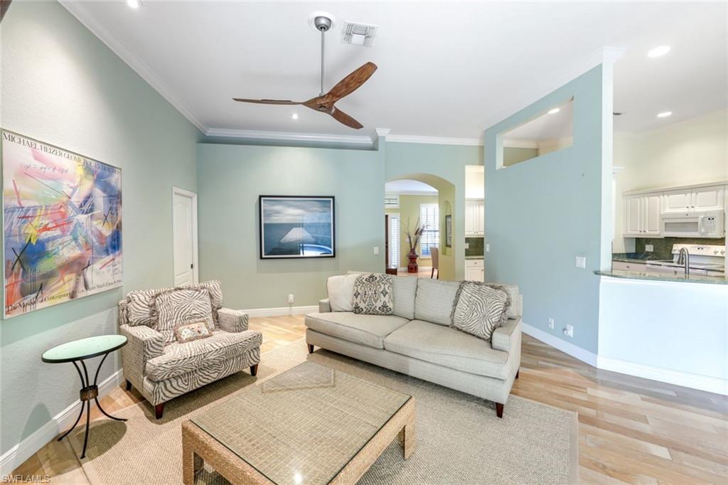302 Sawgrass Court Naples, FL 34110 - Photo 4 of 40 a living room with furniture and a painting