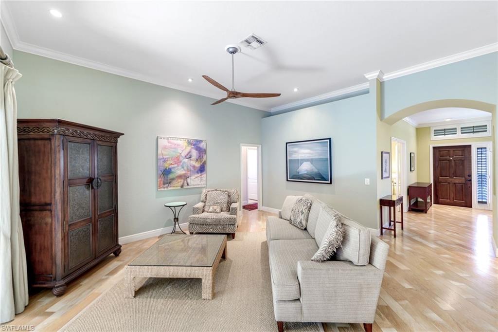 302 Sawgrass Court Naples, FL 34110 - Photo 5 of 40 a living room with furniture and a flat screen tv