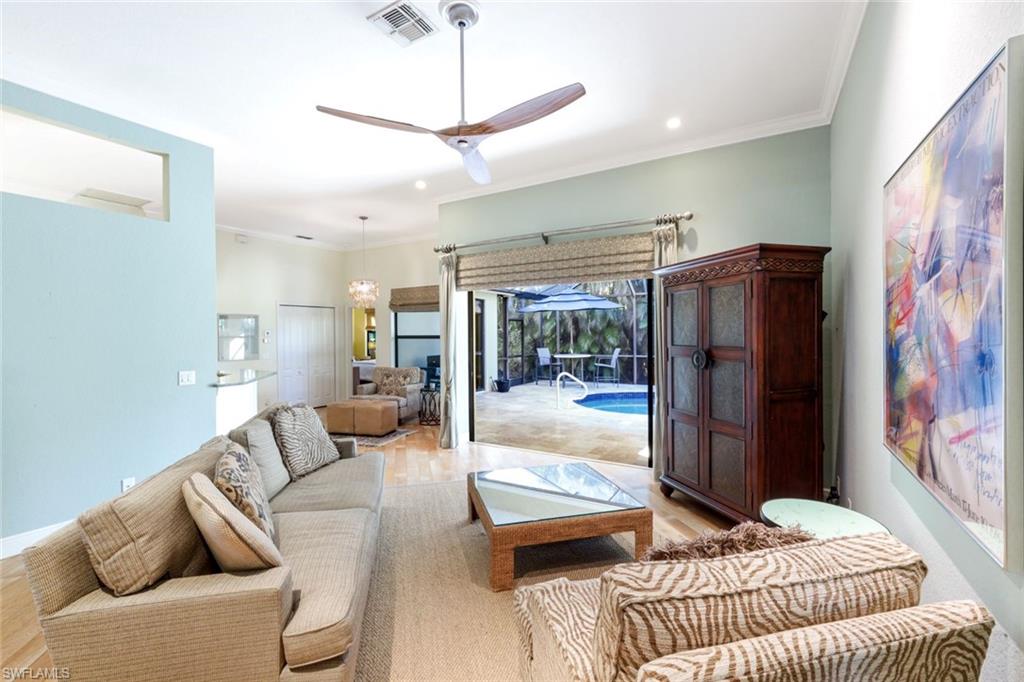 302 Sawgrass Court Naples, FL 34110 - Photo 7 of 40 a living room with furniture and a floor to ceiling window