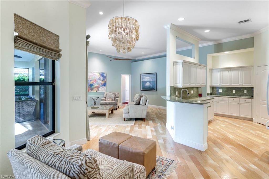 302 Sawgrass Court Naples, FL 34110 - Photo 8 of 40 a living room with furniture and a wooden floor