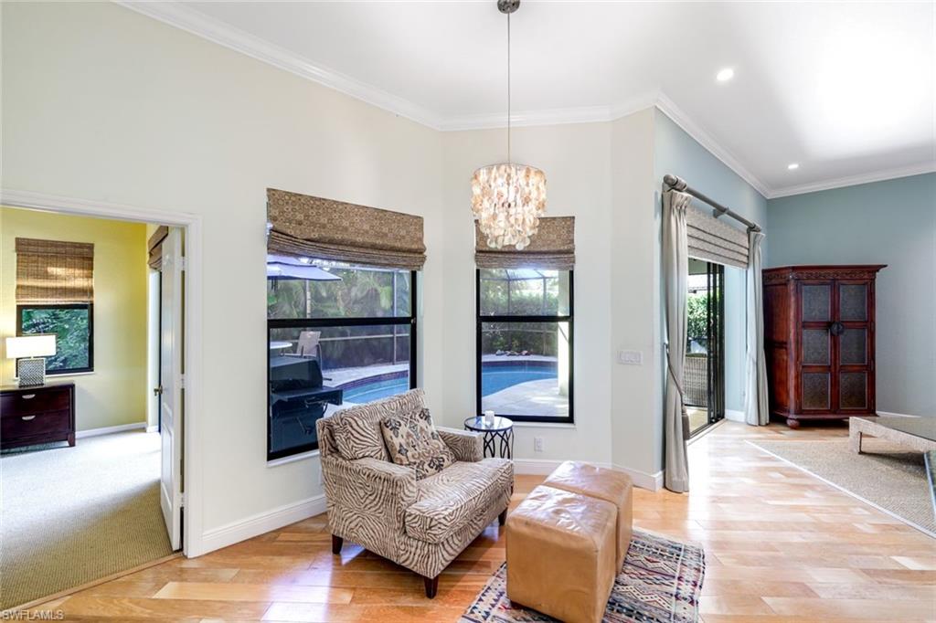 302 Sawgrass Court Naples, FL 34110 - Photo 9 of 40 a living room with furniture and a chandelier