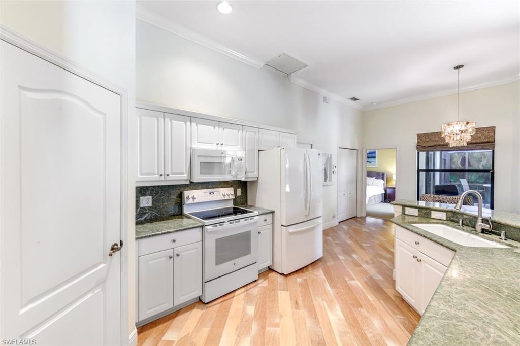 302 Sawgrass Court Naples, FL 34110 - Photo 10 of 40 a kitchen with stainless steel appliances a stove sink and refrigerator