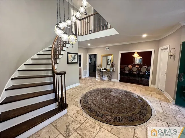 a view of a dining room with furniture a chandelier and wooden floor