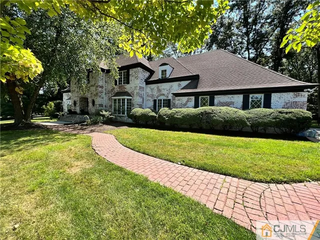 a view of a hallway with wooden floor and entryway
