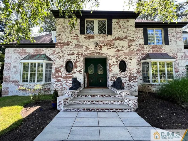 a view of a dining room with furniture a chandelier and wooden floor
