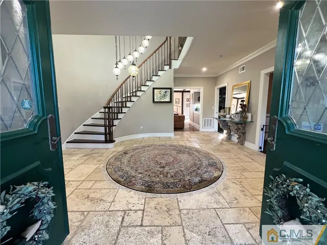 a living room with furniture and a floor to ceiling window