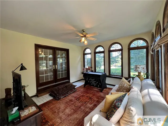 a bedroom with a bed dresser and a potted plant