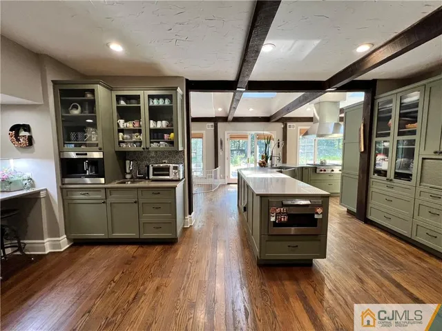 a bathroom with a tub a double vanity sink and mirror