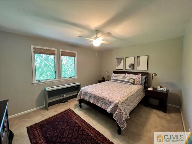 a bathroom with a granite countertop sink mirror vanity and toilet
