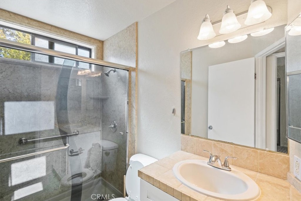 760 Blue Jay Road, Unit 48 Big Bear Lake, CA 92315 - Photo 11 of 31 a bathroom with a sink a toilet and shower